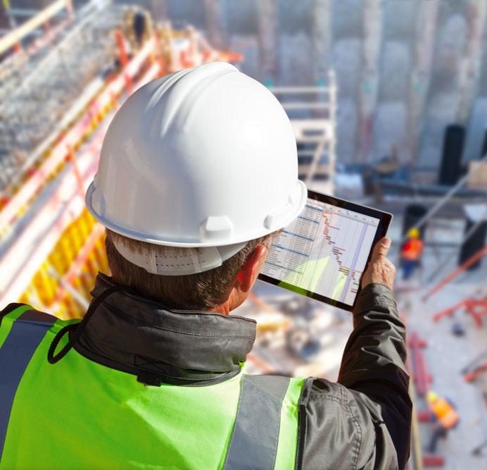Construction worker viewing tablet depicting ecommerce for construction ordering on the go