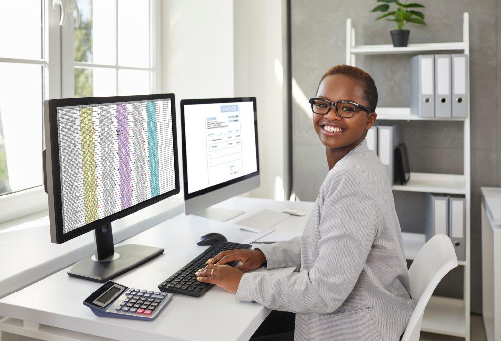 happy-african-american-female-sitting-at-computer-using-ceent-ordering-software