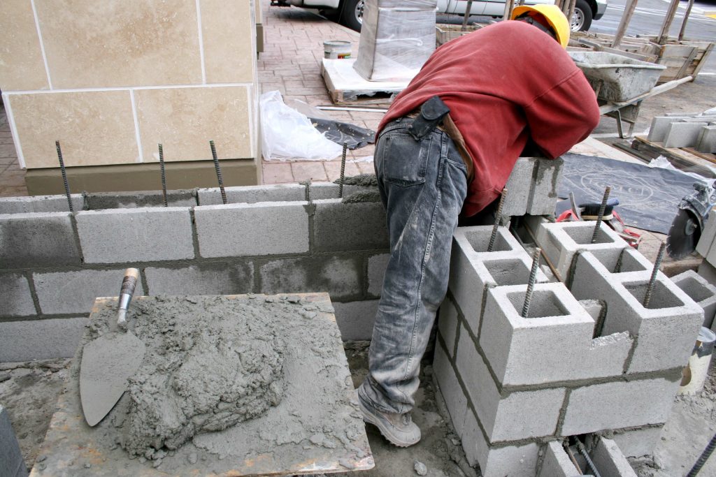 cement-mason-constructing-block-wall-with-mortar-and-cement